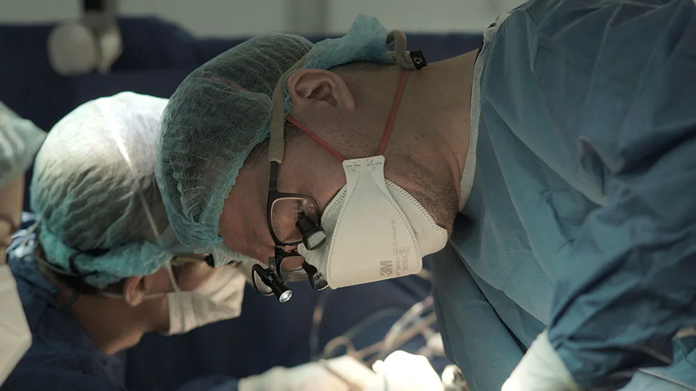 Doctor examining patient with equipment